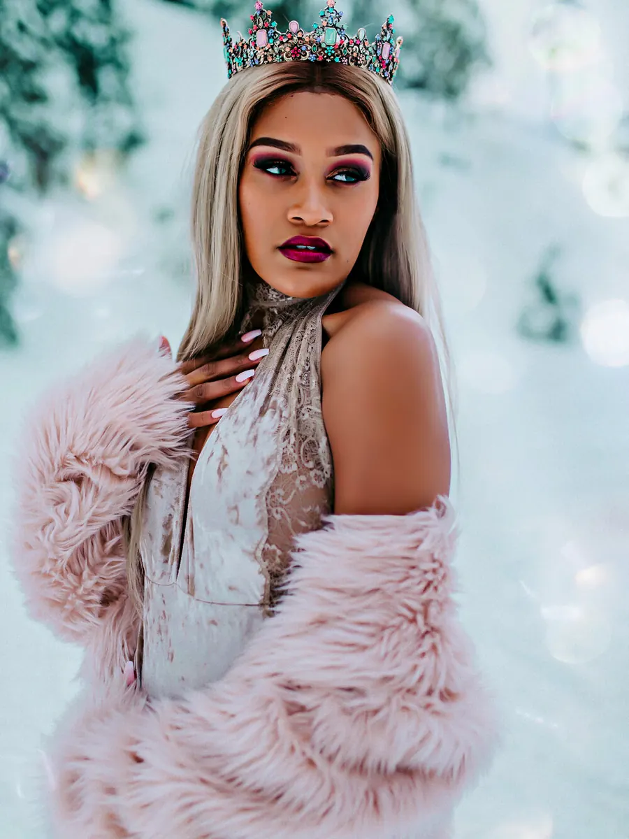 Client with platinum hair in a jewelled crown and a pink faux-fur coat