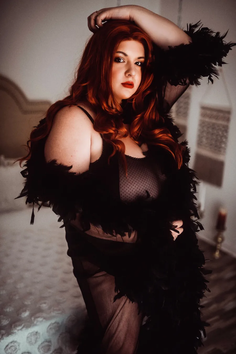 Confident client portrait in a black feather robe